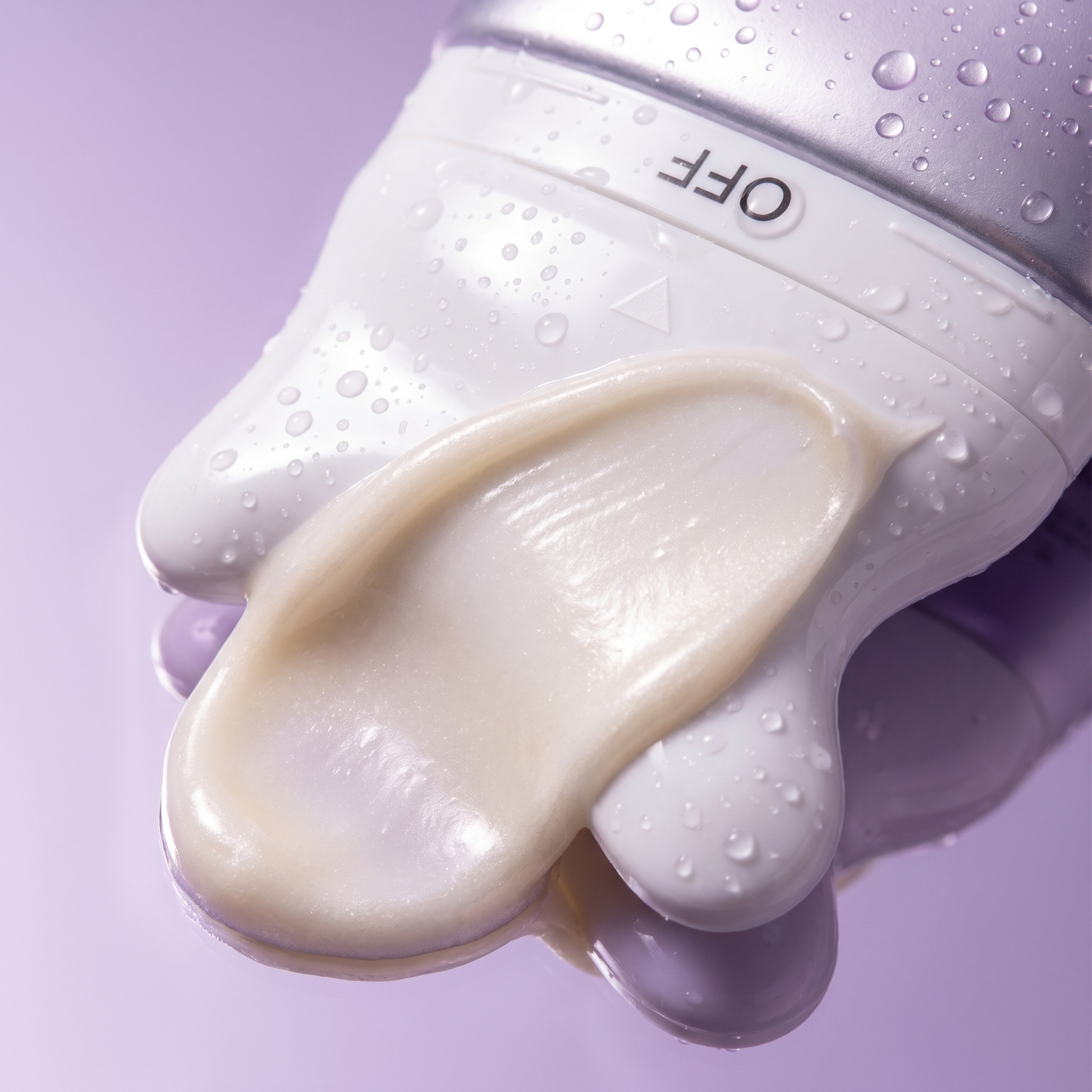 Close-up of the built-in gua sha applicator tip with firming cream